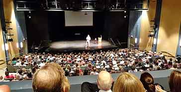Patch Adams speaks at BRI event before over 500 people.